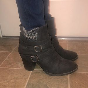 Black faux leather booties with woven ankle detail and side zip.